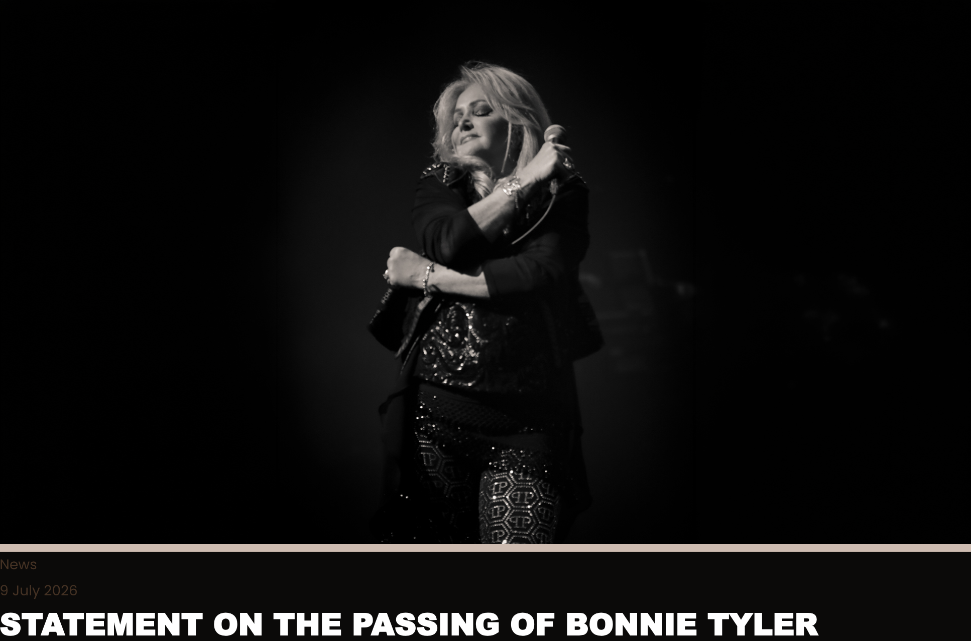 Black-and-white photo of a female singer on stage, holding a microphone with eyes closed in a moment of performance.
