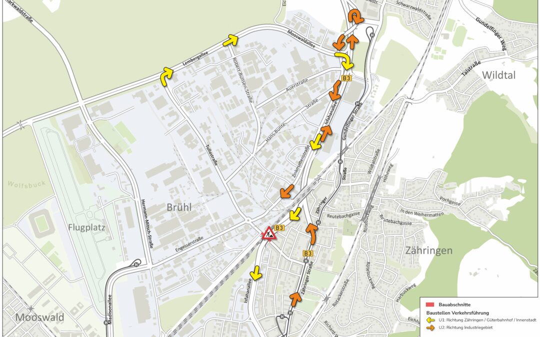 Map of a road-works detour plan in Freiburg area, showing yellow and orange directional arrows along streets (Lembergallee, B3, Zähringer Straße) and surrounding neighborhoods, indicating U1 and U2 routes; construction zones marked by a red triangle in Engesserstraße; legend visible in bottom-right.