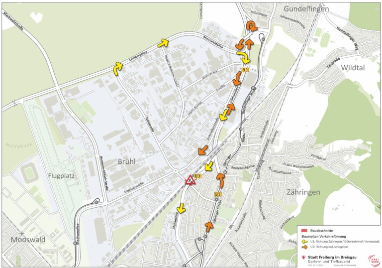 Map of a road-works detour plan in Freiburg area, showing yellow and orange directional arrows along streets (Lembergallee, B3, Zähringer Straße) and surrounding neighborhoods, indicating U1 and U2 routes; construction zones marked by a red triangle in Engesserstraße; legend visible in bottom-right.