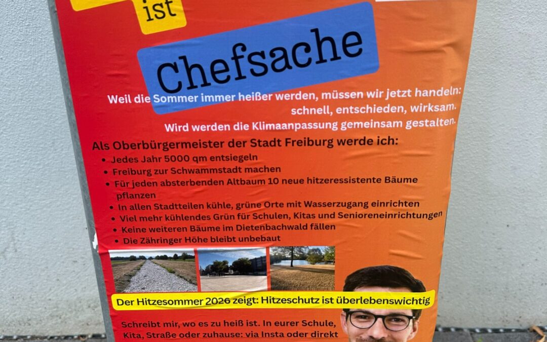 Orange poster on a trash can promoting heat protection in Freiburg; features a blue 'Chefsache' label and a portrait photo at the bottom.
